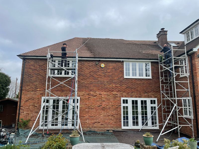 Roof cleaning carried out safely from scaffold towers by The Roof Moss Cleaners in Royal Leamington Spa